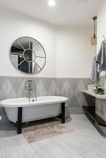 freestanding bathtub, round mirror, modern bathroom, contemporary decor, stylish design, white clean bathtub, round shaped mirror, bathroom design, freestanding tub, modern decor, bathroom mirror