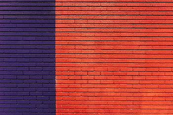 red and purple wall, brick wall, bold colors, striking visual, linear patterns, texture, red bricks, purple bricks, architectural design, urban art, modern design