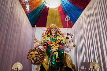 Durga Devi, Mumbai, India, Festival of Navratri, Durga Puja, Goddess Durga, vibrant setting, statue, lion, colorful backdrop, religious celebration