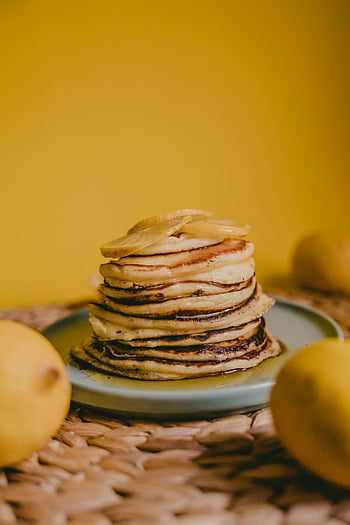 stack of pancakes, homemade pancakes, garnished pancakes, lemons, vibrant yellow background, breakfast themes, stack pancakes, lemon pancakes, yellow background, breakfast food, homemade breakfast