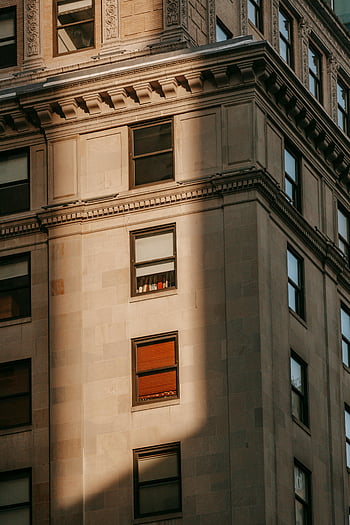 old multistory house, classic urban building, geometric patterns, building facade, town architecture, ornamented facade, urban architecture, shadow play, historic building, architectural details, window patterns