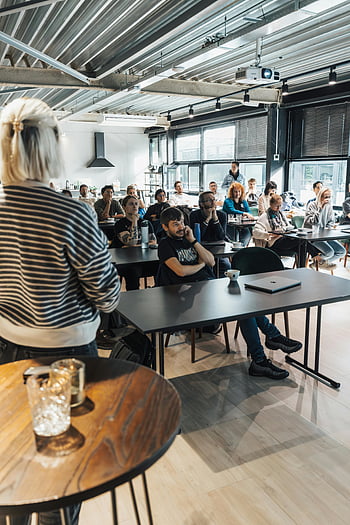 business training course, modern classroom, diverse adults, educational presentation, professional development, group learning, adult education, interactive session, workshop setting, business seminar, training workshop