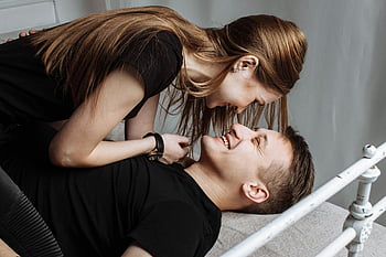 joyful couple, intimate moments, laughter, bed, indoors, smiling woman, young couple, happy couple, playful moment, indoor scene, couple laughing