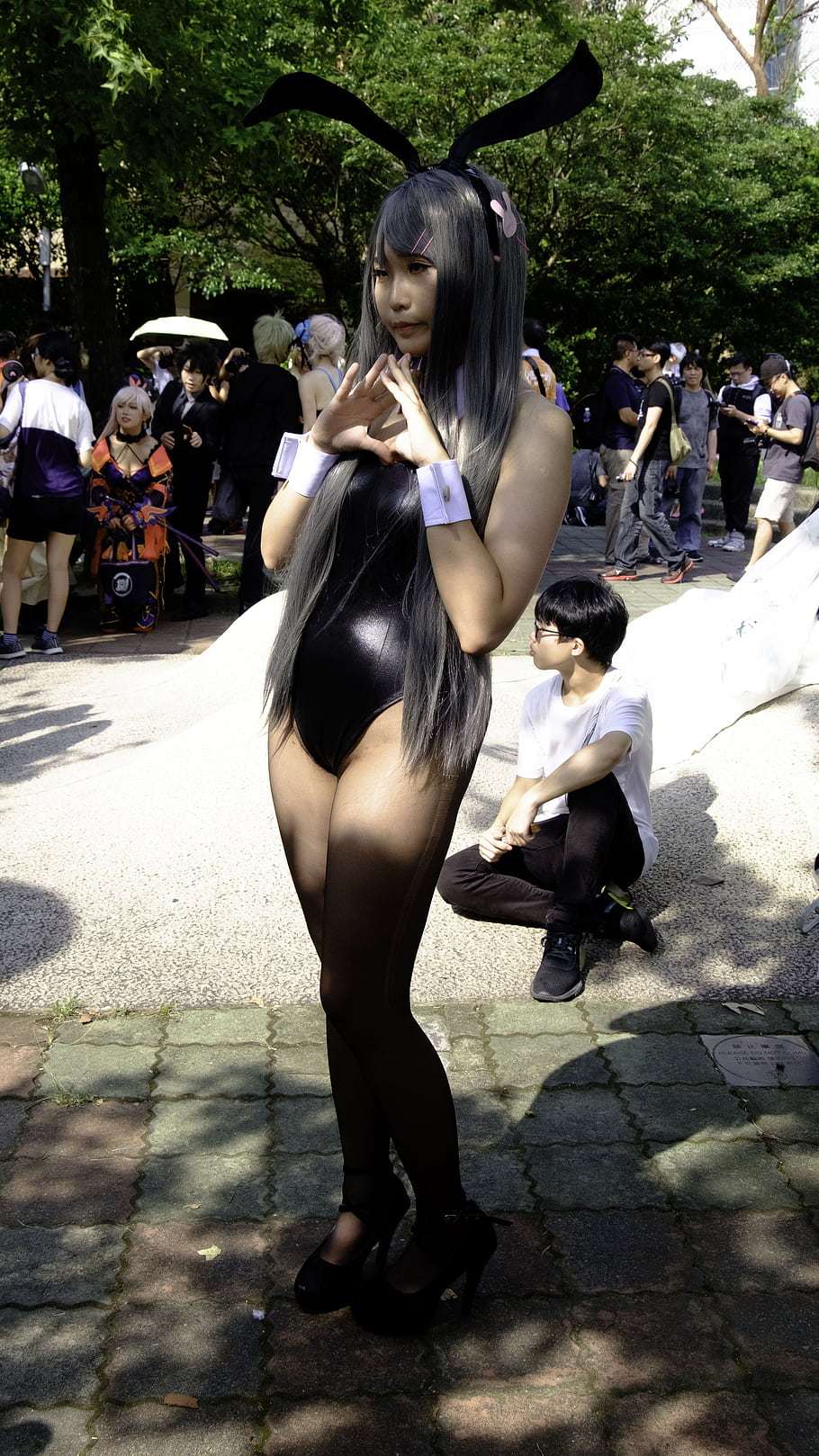 cosplay, bunny girl, costume, event, crowd, outdoors, photography, black outfit, high heels, rabbit ears, festival