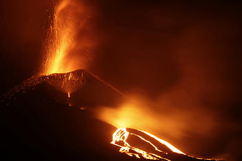 volcano eruption, lava flow, night scene, volcanic sparks, dramatic landscape, flowing lava, powerful eruption, volcanic activity, night eruption, volcanic landscape, lava on volcano