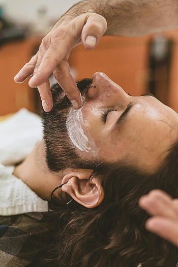 shaving cream, facial hair, beard trim, barber shop, man with long hair, shaving application, facial treatment, grooming, skincare, barber services, male grooming