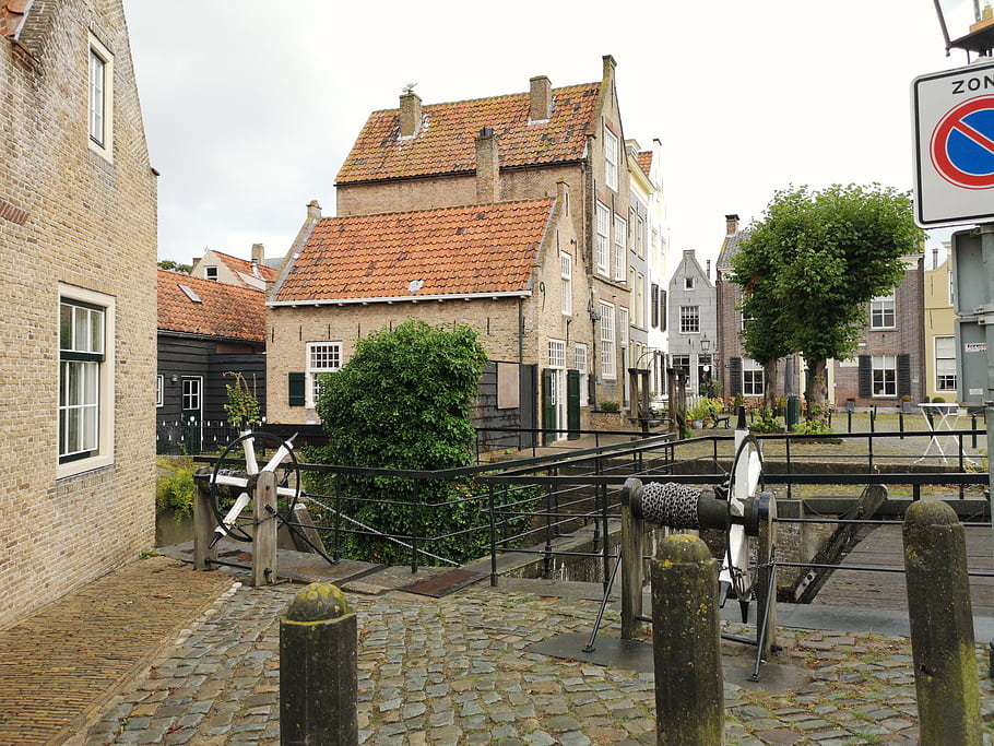 Netherlands, Goedereede, canal, lock, waterway, brick buildings, cobblestone street, trees, sign, architecture, town