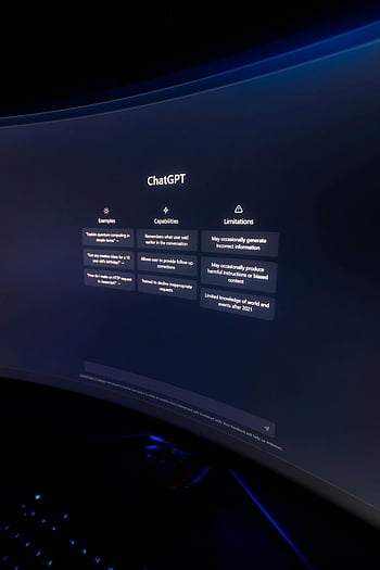 ChatGPT, curved monitor, dimly lit, interface, text on monitor, close-up, capabilities, limitations, examples, AI, technology