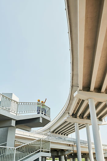 construction worker, bridge structure, modern architecture, concrete structure, people standing, bridge inspection, urban infrastructure, architectural design, outdoor scene, engineering inspection, safety gear