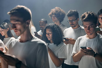 smartphones, diverse adults, modern technology, social connectivity, indoors, group photo, focused individuals, technology use, smartphone addiction, digital engagement, smart devices