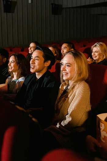 people at theater, diverse group, enjoying movie, cinema, smiles, popcorn, friends, movie night, theater audience, cinema experience, movie watching