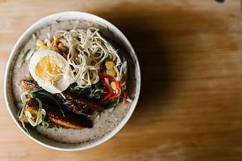 Japanese ramen, white ceramic bowl, cooked food, traditional ramen, appetizing bowl, ramen toppings, ramen egg, top view, noodle dish, ramen ingredients, ramen preparation