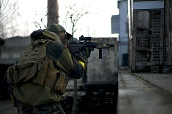 camouflage jacket, rifle, soldier, urban environment, ready for action, military gear, tactical vest, outdoor scene, combat gear, prepared soldier, camouflage uniform