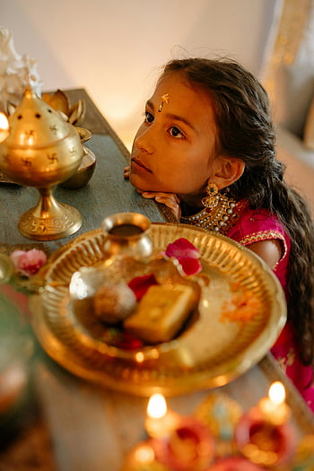 girl, red dress, gold jewelry, traditional attire, Diwali decorations, candles, indoor, young girl, festive, cultural, celebration
