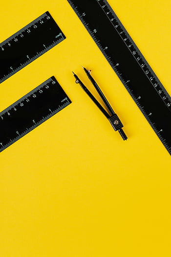 black measuring tools, yellow background, flat lay, rulers, compass, education, math themes, school supplies, black rulers, bright yellow, measurement tools