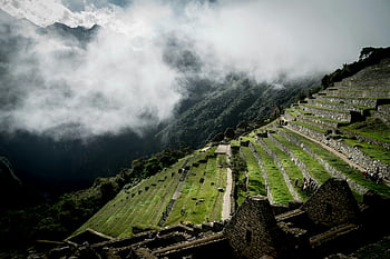 Machu Picchu, terraced fields, Lost City of the Incas, morning mist, ancient Inca architecture, tourists, iconic terraces, breathtaking view, Inca ruins, travel destination, Peru