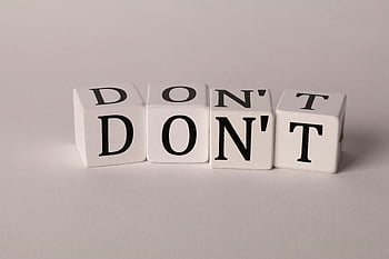 letters on dice, text cubes, spelling DON'T, clean white background, caution concept, prohibition concept, dice letters, white dice, black text, minimalistic design, warning message