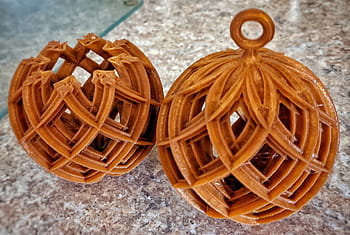 3D printing, first try, second try, spherical objects, lattice design, orange color, marble surface, comparison, prototype, craftsmanship, blog content