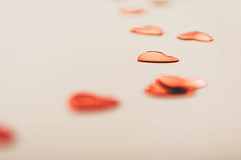 red heart shape, white surface, Valentine's Day, romantic themes, red heart confetti, soft beige surface, heart confetti, romantic decoration, Valentine's decoration, heart shapes, romantic photo