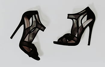 black high heels, white surface, mesh design, fashion footwear, high heel sandals, stylish shoes, black sandals, shoe photography, women's footwear, elegant shoes, black mesh heels