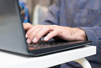 close-up shot, person typing, laptop keyboard, hands typing, focused setting, professional setting, close-up hands, laptop close-up, typing hands, work environment, office setting