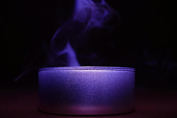blue candle, close-up, black background, dimly lit, smoky purple, relaxation, ambiance, candle light, mood lighting, aromatic candle, candle smoke