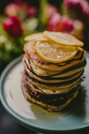 pancakes, lemon slices, stack of pancakes, delicious pancakes, stylish plate, breakfast food, lemon topped pancakes, food photography, breakfast dish, pancake stack, lemon pancakes