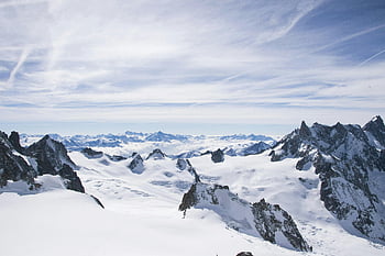 Mont Blanc, snowy summit, icy peaks, rugged mountains, blue sky, breathtaking view, alpine landscape, high altitude, winter scenery, snow-covered peaks, mountain range