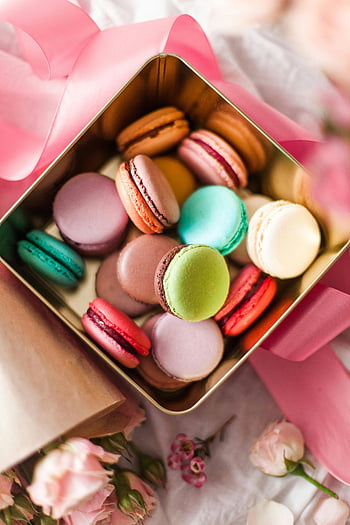 macarons, gold-plated box, pink ribbon, vibrant macarons, gifting, colorful macarons, dessert, sweet treats, gift box, macaroon assortment, floral background