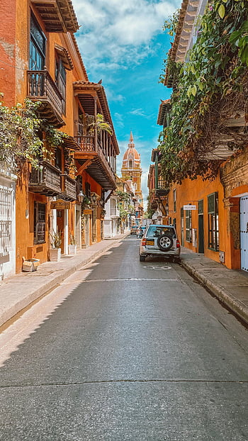 Cartagena, Cathedral Tower, charming street, vibrant buildings, travel inspiration, street view, historic architecture, colonial buildings, Cartagena Colombia, travel destination, cathedral in view