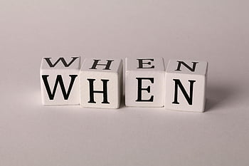 text on dice, wooden blocks, word WHEN, minimalist photo, white background, dice letters, WHEN text, block letters, simple design, clean background, typography art