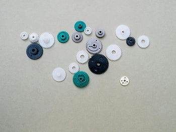 plastic gears, assorted colors, mechanical components, DIY projects, colorful gears, plastic components, gear collection, plain surface, mechanical concepts, DIY concepts, plastic gear lot