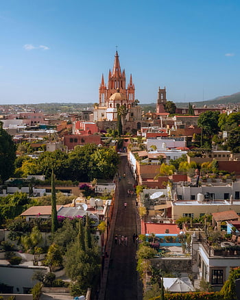 San Miguel de Allende, Mexico, townscape, stunning architecture, vibrant urban scene, aerial view, church, cityscape, historic buildings, rooftop gardens, blue sky