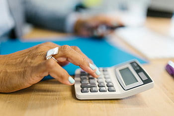 manicured hand, gray desk calculator, blue folder, shallow depth of field, office desk, calculator use, close-up hand, desk workspace, office tools, financial calculations, workplace tools