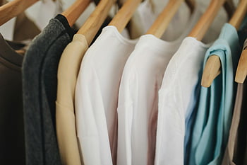 white long sleeves shirts, brown wooden clothes hanger, colorful clothes, wooden hangers, retail store, neatly hanging, clothing display, fashion retail, apparel store, clothing rack, retail fashion