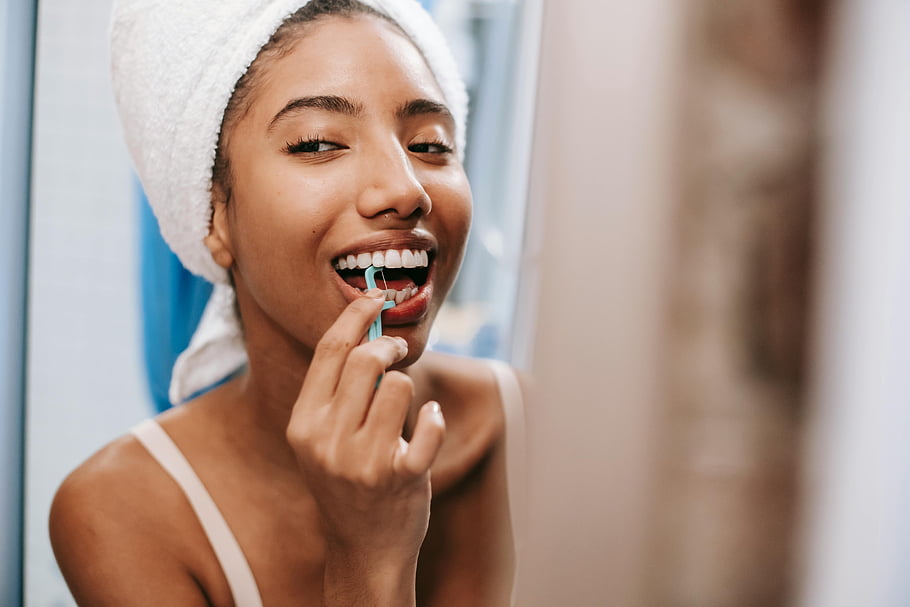 oral hygiene, flossing teeth, cheerful woman, young woman, towel on head, dental care, flosser, healthy teeth, bathroom routine, personal care, daily habits