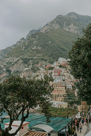 Positano wedding photographer, colorful buildings, Amalfi Coast, hillside, scenic view, Positano, Italy, coastal town, mountain backdrop, Mediterranean, travel photography