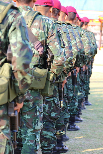 camouflage military suit, green and brown, soldiers, holding rifles, outdoor lineup, berets, group of soldiers, military uniforms, camouflage uniforms, rifles, outdoor setting