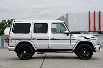 Mercedes G Class, white Mercedes G-Class, elegantly designed SUV, outdoor setting, modern automotive enthusiasts, Mercedes G-Class SUV, luxury vehicle, high-end SUV, white SUV, Mercedes-Benz G-Class, outdoor showcase