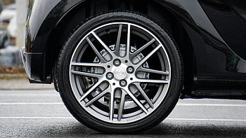 chrome vehicle wheel, car wheel, black vehicle, automotive design, detailed shot, sleek car wheel, rim, car rim, close-up photograph, tire, wheel design