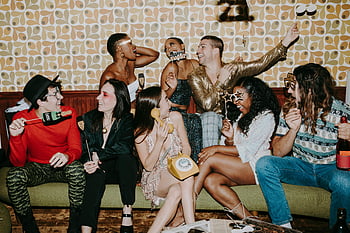 New Year's Eve party, festive decorations, group of friends, laughter, indoor party, social gathering, costumes, diverse, playful, trendy, young adults