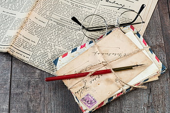 eyeglasses, newspaper, mail envelopes, vintage glasses, old letters, ink pen, wooden surface, close-up, antique, retro, correspondence