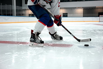 ice hockey, hockey stick, ice rink, hockey player, sports gear, agility, puck, focused player, hockey action, indoor rink, hockey equipment