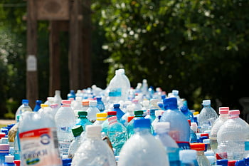 plastic bottles, recycling, outdoor setup, environmental awareness, vibrant collection, assorted bottles, plastic recycling, outdoor recycling, plastic waste, eco-friendly, sustainable practices