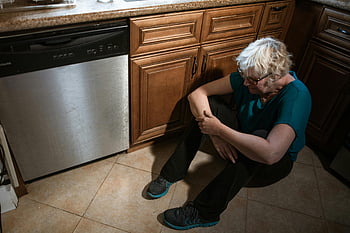 elderly woman, depressed, sitting alone, floor, kitchen, sad, loneliness, senior woman, depression, emotional distress, home setting