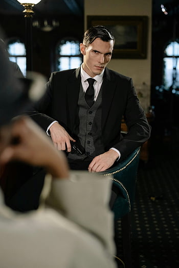 man in black, holding a gun, noir-style scene, detective, suspect, vintage bar, atmosphere, moody, suit, tie, vest