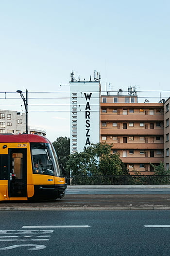 tram in Warsaw, vibrant cityscape, Warsaw Poland, passing tram, urban buildings, city transportation, tram 3130, Warsaw sign, city street, modern tram, tramway system