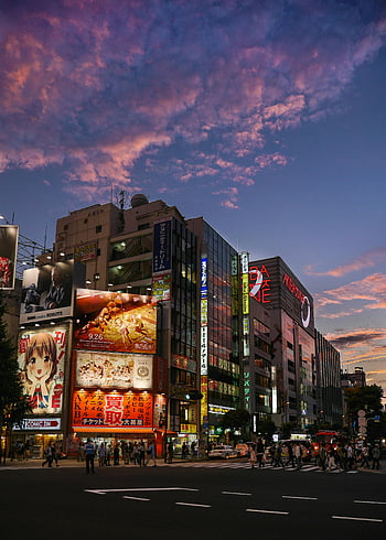 Akihabara, Tokyo, street scene, colorful billboards, lively crowd, dusk, people crossing, intersection, vibrant, cityscape, Japan