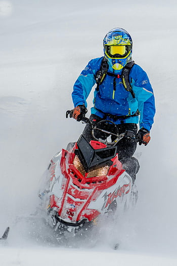 snowmobile ride, snowy landscapes, winter sports, blue jacket, helmet, red snowmobile, snowmobile adventure, winter adventure, outdoor sports, snowmobile enthusiast, snowmobile experience