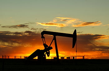 oil well, sunset, pump jack, silhouette, vibrant sky, energy extraction, oil field, industrial landscape, natural resources, oil production, dramatic scene